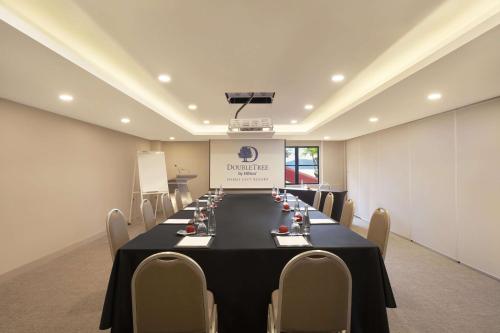 a conference room with a long table and chairs at DoubleTree by Hilton Damai Laut in Lumut