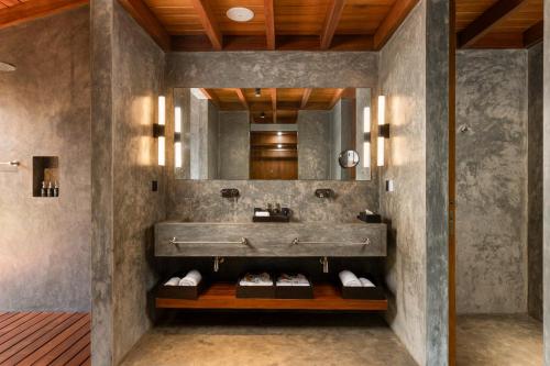 a bathroom with a sink and a mirror at Villa Thamburu, Bentota in Bentota