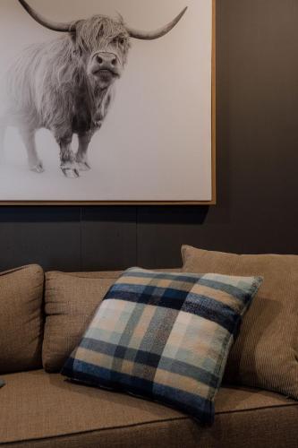 a pillow on a couch with a picture of a bull at TWO Prefab Living - Luxury bungalows in Dullstroom