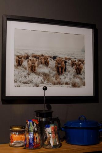 a picture of a herd of buffalo on a wall at TWO Prefab Living - Luxury bungalows in Dullstroom