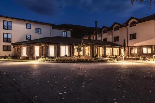 a row of buildings at night at BIO HOTEL & WELLNESS Zlatý Hýľ in Hýľov