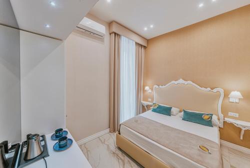 ナポリにあるGentile Suite & Spa Vomeroのベッドと窓のあるホテルの部屋