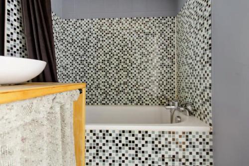 a bathroom with a sink and a bath tub at Artist Retreat in Noisy-le-Grand