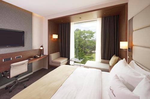 a hotel room with a large bed and a window at DoubleTree by Hilton Zagreb in Zagreb