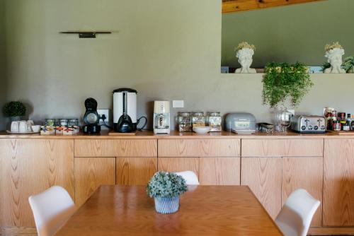 a kitchen with a table and a counter with appliances at Agapé Boutique Guesthouse Bothaville in Bothaville