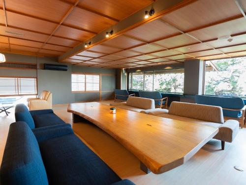 a living room with a large wooden table and chairs at 18歳以上の宿 澄江知多 in Utsumi