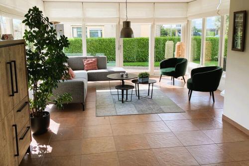 a living room with a couch and chairs and a table at Luxurious Holiday Home in Koudum with Pool in Koudum