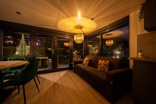 a living room with a couch and a table at Houseboats Mookerplas in Middelaar