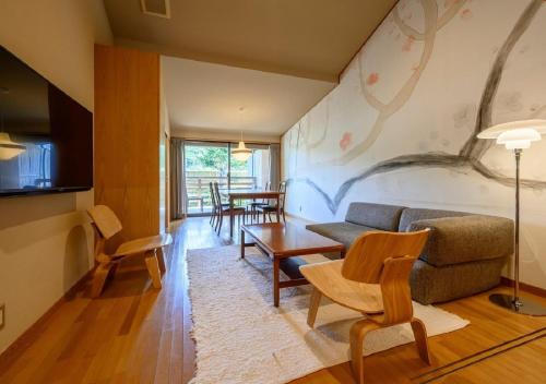 a living room with a couch and a table at Kawatana Grand Hotel Otafuku in Shimonoseki