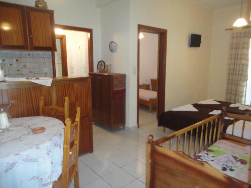 a living room with a kitchen and a dining room at Archontika Apartments in Kerames