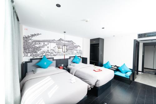 Postel nebo postele na pokoji v ubytování Gongxili - Pujian Hotel