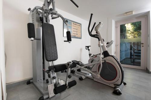 a gym with a treadmill and a exercise bike at Villa Paggi Country House in Carasco