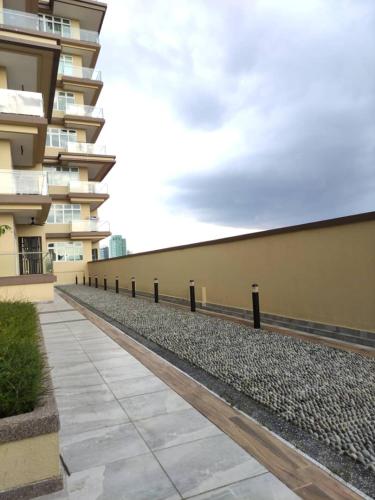 a sidewalk in front of a building with a fence at Senandika Homestay in Kuching