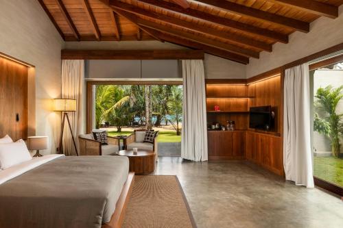 - une chambre avec un lit et un salon dans l'établissement Villa Thamburu, Bentota, à Bentota