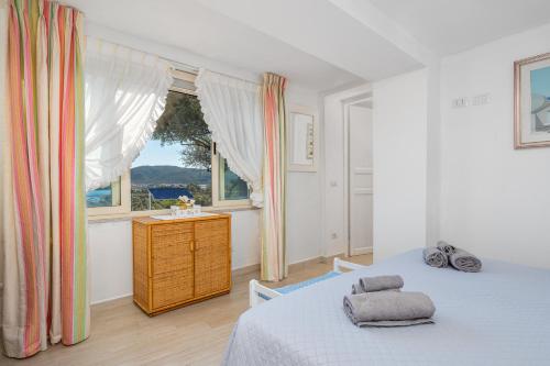 Postel nebo postele na pokoji v ubytování Bella Vista Marinella 2