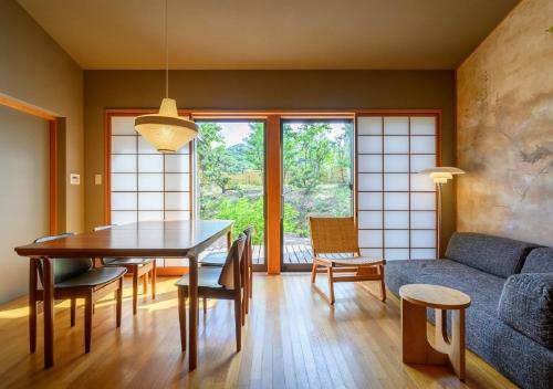 a living room with a table and a couch at Kawatana Grand Hotel Otafuku in Shimonoseki