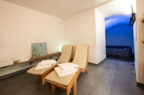 a group of chairs in a room with a painting at Villa Paggi Country House in Carasco