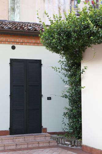 a black door on the side of a white house at Abbazia Bed & Breakfast, MantegnaHotels in Mantova