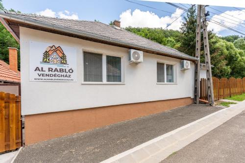a house with aania sign on the side of it at Al Rabló Vendégház in Mátrakeresztes