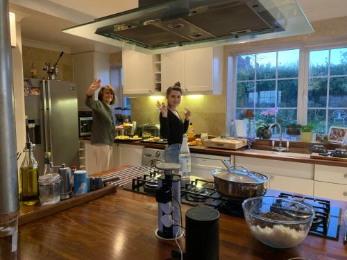 two women standing in a kitchen with their hands in the air at Goodwood Chichester, (more interior pics coming) in Tangmere