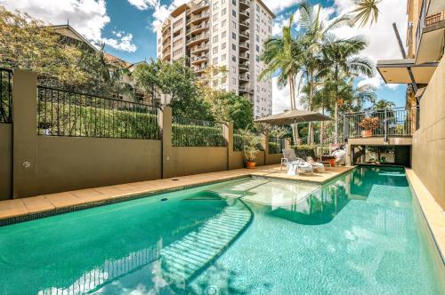 a swimming pool in front of a building at Il Mondo Boutique Hotel in Brisbane