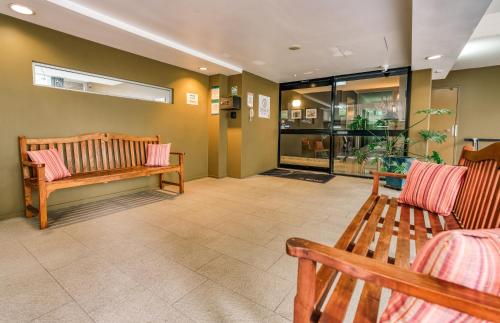 a waiting room with two benches and a window at Il Mondo Boutique Hotel in Brisbane