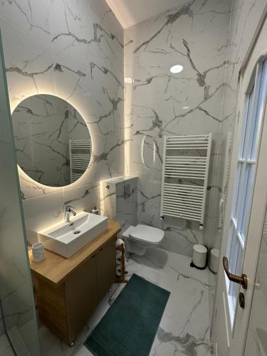 a bathroom with a sink and a mirror at Oyster Flat Victoriei in Bucharest