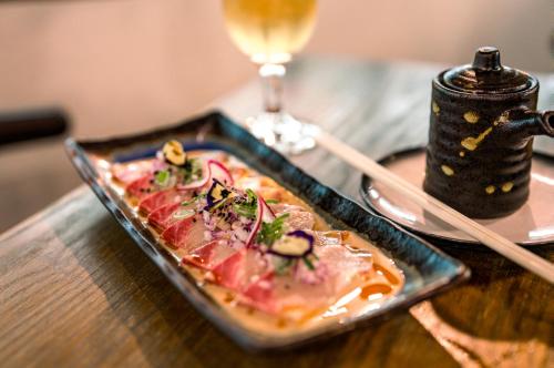 a plate of food on a table with a drink at Il Mondo Boutique Hotel in Brisbane