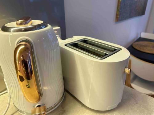 a white toaster sitting on top of a counter at Nest Apartments on Rose Lane in Melbourne