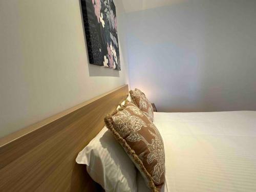 a bedroom with a bed with a pillow on it at Nest Apartments on Rose Lane in Melbourne