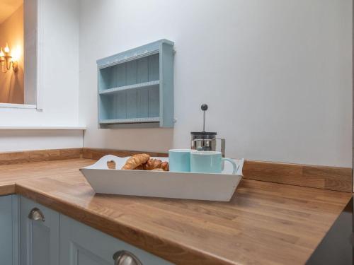 a kitchen counter with a tray of pastries on it at Foxbear in Kingsbridge