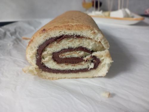 a roll sitting on top of a white table at LA TANA DELLA VOLPETTA - Bed & Breakfast in Stella