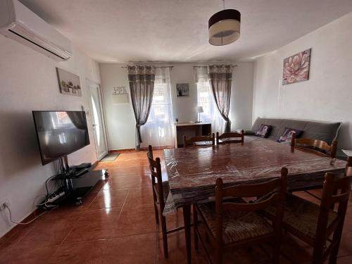 a dining room with a table and chairs and a television at Casa do Castelo in Valhelhas