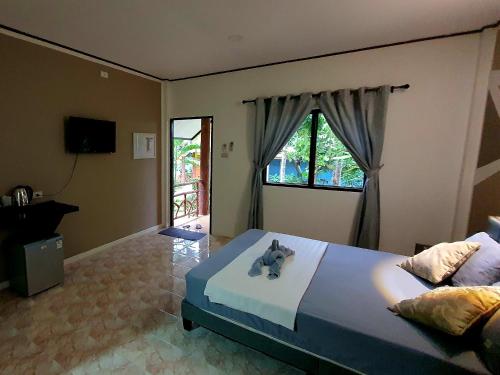 a bedroom with a bed with an elephant on it at DolceVita Wonderful Resort in Ko Lanta