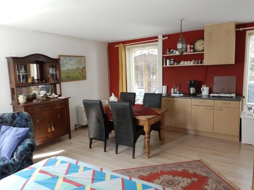 a kitchen and dining room with a table and chairs at Drenthse-Groninger landschap in Haren