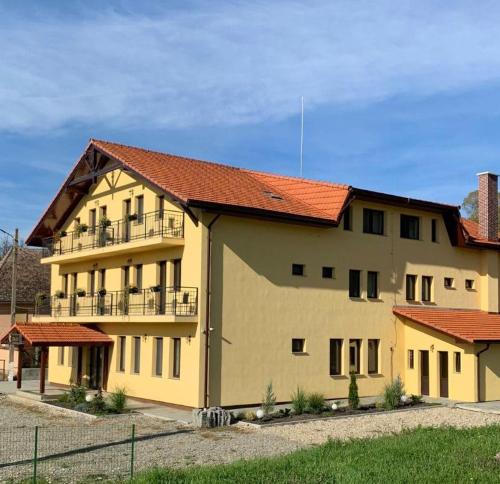 a large yellow building with a red roof at Residenz Zikeli 