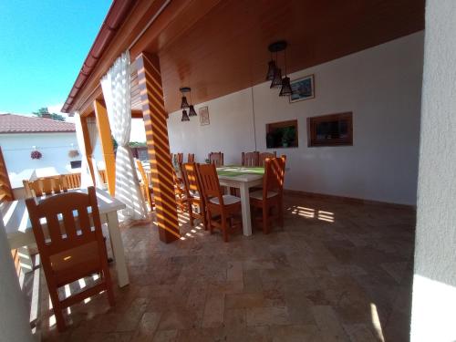 a dining room with a table and chairs at Pestele Ca Odinioară in Murighiol
