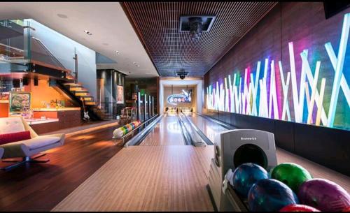 a bowling alley with pins and balls on the lanes at King's Square Lux apartment Zlatibor 1 in Zlatibor