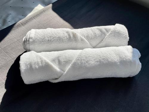 a pair of white towels on top of a table at Comfortable 3-BR Home Great Location in Ashby in Ashby de la Zouch