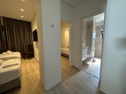 Ένα ή περισσότερα κρεβάτια σε δωμάτιο στο Hotel Trifoni