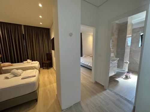Ένα ή περισσότερα κρεβάτια σε δωμάτιο στο Hotel Trifoni