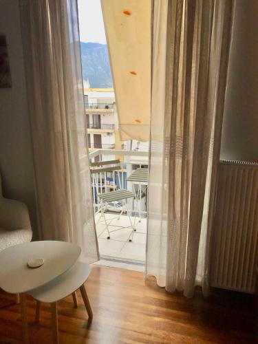 a room with a window with a view of a balcony at Elegant Downtown Retreat in Kalamata