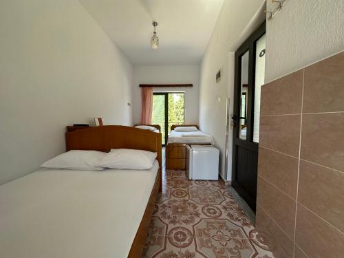 Ένα ή περισσότερα κρεβάτια σε δωμάτιο στο Hotel Trifoni