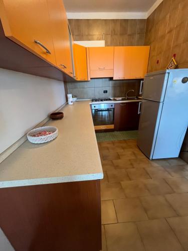 a kitchen with orange cabinets and a refrigerator at Casa Morello in Zambrone