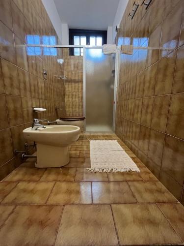 a bathroom with a shower and a toilet and a sink at Casa Morello in Zambrone