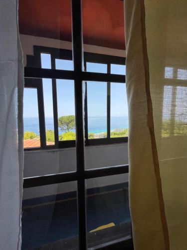 a room with a window with a view of the ocean at Casa Morello in Zambrone