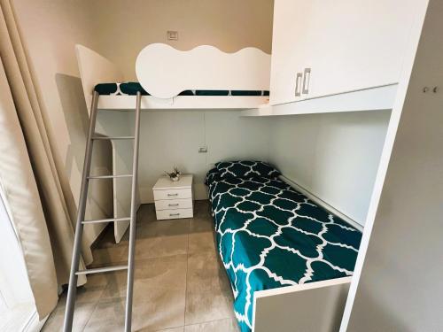a small room with a bunk bed and a ladder at Casa vacanze Sardegna B in Tertenìa