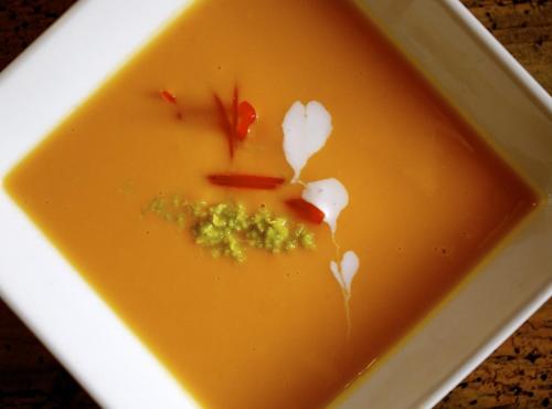 a bowl of soup with broccoli and flowers in it at Black Diamond Sainte Foy Chalets in Sainte-Foy-Tarentaise