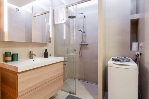 a bathroom with a shower and a sink and a toilet at LeoApart in Wrocław