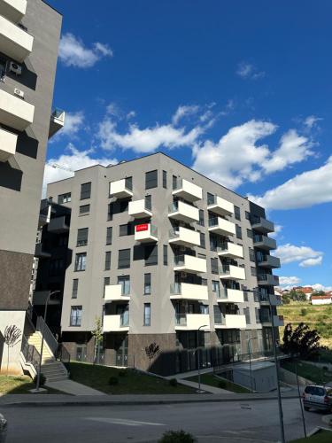 an apartment building with balconies on the side of a street at AirStay in Prishtinë